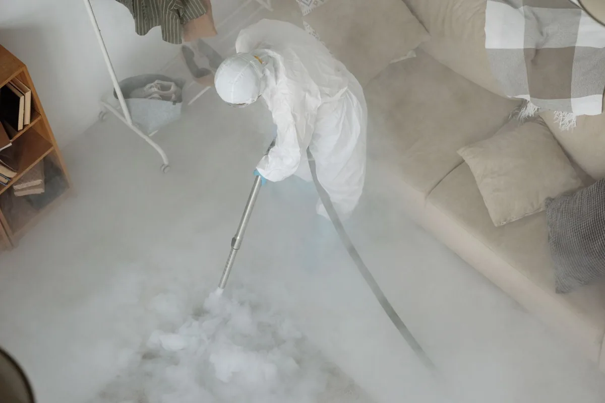 Biohazard cleanup technician in protective equipment, Oronogo, MO